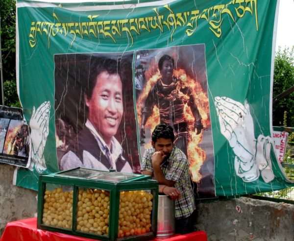 It's tough to avoid the images of monks on fire in McLeod Ganj, as the signs are everywhere...like this one next to the Dalai Lama compound and behind a street food vendor It's tough to avoid the images of monks on fire in McLeod Ganj, as the signs are everywhere...like this one next to the Dalai Lama compound and behind a street food vendor